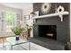 Elegant black brick fireplace with a white mantel, complemented by hardwood floors and decor at 2481 Foxwood Dr, Chapel Hill, NC 27514