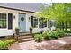 Charming home featuring a light blue front door with classic black shutters and a brick walkway at 2481 Foxwood Dr, Chapel Hill, NC 27514