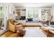 Sun-drenched living room with built-in bookshelves, hardwood flooring, large windows with natural light, and comfortable seating at 2481 Foxwood Dr, Chapel Hill, NC 27514
