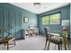 This home office has blue walls, a glass top desk, and built-in shelving at 2481 Foxwood Dr, Chapel Hill, NC 27514