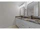Bathroom featuring dual sinks with granite countertops and modern fixtures at 2505 Catalina Ct, Raleigh, NC 27607
