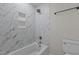 Bright bathroom with white tiles, bathtub, a shower head, and modern fixtures at 2505 Catalina Ct, Raleigh, NC 27607