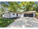 Charming renovated home with stone accents, attached garage and a well-manicured front yard with mature trees at 2505 Catalina Ct, Raleigh, NC 27607