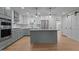 Stylish kitchen featuring a center island, stainless steel appliances and sliding door access at 2505 Catalina Ct, Raleigh, NC 27607
