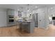 Open concept kitchen with stainless appliances, bar seating, and hardwood floors at 2505 Catalina Ct, Raleigh, NC 27607