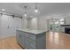 Open kitchen featuring an island with stone countertops, stainless steel appliances and hardwood flooring at 2505 Catalina Ct, Raleigh, NC 27607