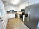 Well-lit kitchen with stainless steel appliances, white cabinets, and tile backsplash, perfect for home cooking at 2600 Newbold St, Raleigh, NC 27603