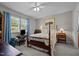 Comfortable bedroom boasts a four-poster bed and a window for natural light at 2614 Cambridge Rd, Burlington, NC 27215