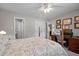 Bedroom boasts a four-poster bed and a wooden desk workspace near the closet and bathroom at 2614 Cambridge Rd, Burlington, NC 27215