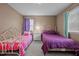 Bright bedroom with two twin beds, a ceiling fan, and natural light at 2614 Cambridge Rd, Burlington, NC 27215