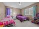 Bright bedroom with two twin beds, a ceiling fan, and natural light at 2614 Cambridge Rd, Burlington, NC 27215