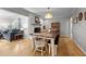 Open-concept dining room with hardwood floors, fireplace, and view into the adjacent living room at 2614 Cambridge Rd, Burlington, NC 27215