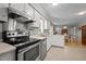 Kitchen features stainless steel appliances with an opening to the dining room at 2614 Cambridge Rd, Burlington, NC 27215