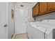 Spacious laundry room with a washer and dryer and overhead cabinets at 2614 Cambridge Rd, Burlington, NC 27215