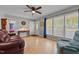 Inviting living room with hardwood floors, neutral walls, and bright windows with blue accents at 2614 Cambridge Rd, Burlington, NC 27215