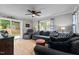 Cozy living room with hardwood floors, a ceiling fan, and access to the backyard through sliding doors at 2614 Cambridge Rd, Burlington, NC 27215