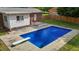 Backyard pool with diving board and ladders, surrounded by concrete and leading up to a house with white siding and brick details at 2614 Cambridge Rd, Burlington, NC 27215