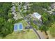 Aerial image showcasing community amenities, including a tennis court and pool, surrounded by lush greenery at 27 Woodgate Ct, Durham, NC 27713