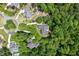 Expansive aerial view of a neighborhood surrounded by mature trees, highlighting the community's peaceful atmosphere at 27 Woodgate Ct, Durham, NC 27713