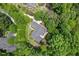 Overhead view of a home situated on a spacious lot with mature trees, providing privacy and a connection to nature at 27 Woodgate Ct, Durham, NC 27713