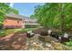 Inviting backyard featuring a stone patio with a fire pit and comfortable seating at 27 Woodgate Ct, Durham, NC 27713