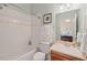 Neutral toned bathroom with tub and shower combo and wood vanity at 27 Woodgate Ct, Durham, NC 27713