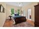 Bedroom with hardwood floors and an adjoining bathroom at 27 Woodgate Ct, Durham, NC 27713