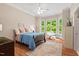 Bedroom with bay window with seat, hardwood floors, and neutral walls at 27 Woodgate Ct, Durham, NC 27713