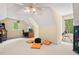 Upstairs bonus room with pitched ceiling, fan, and an arcade game at 27 Woodgate Ct, Durham, NC 27713