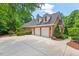 Charming brick home with a three-car garage and well-manicured landscaping, offering great curb appeal at 27 Woodgate Ct, Durham, NC 27713