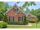 Charming traditional brick home with lush landscaping and a well-manicured lawn at 27 Woodgate Ct, Durham, NC 27713