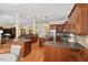 Expansive kitchen featuring dark wood cabinetry, hardwood floors, and an adjacent living area at 27 Woodgate Ct, Durham, NC 27713