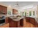 Spacious kitchen featuring custom cabinets, an island, and hardwood floors, providing an inviting atmosphere at 27 Woodgate Ct, Durham, NC 27713