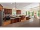 Spacious kitchen with dark wood cabinets, stainless steel appliances, and a large island and breakfast area at 27 Woodgate Ct, Durham, NC 27713