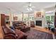 Cozy living room featuring a fireplace, hardwood floors, and comfortable seating with lots of light at 27 Woodgate Ct, Durham, NC 27713