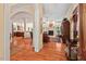 Open-concept living room with hardwood floors, fireplace, and ample natural light, flowing into the kitchen at 27 Woodgate Ct, Durham, NC 27713