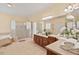 Luxurious bathroom with a glass shower, soaking tub, and plenty of natural light at 27 Woodgate Ct, Durham, NC 27713