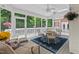 Cozy screened porch with comfortable seating and ceiling fans, perfect for outdoor relaxation at 27 Woodgate Ct, Durham, NC 27713