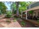 Secluded backyard with a large tree, a porch swing, and manicured landscaping at 2704 Fairview Rd, Raleigh, NC 27608