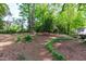 Spacious backyard with mature trees and lush, green foliage at 2704 Fairview Rd, Raleigh, NC 27608