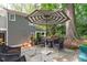 Cozy backyard patio area with stone pavers, seating, and an umbrella at 2704 Fairview Rd, Raleigh, NC 27608