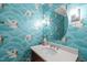 Stylish powder room featuring crane-themed wallpaper, modern fixtures, and an oval mirror at 2704 Fairview Rd, Raleigh, NC 27608