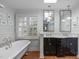Bright bathroom featuring double sinks, skylight, tub and beautiful natural lighting at 2704 Fairview Rd, Raleigh, NC 27608