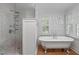 Elegant bathroom featuring a clawfoot tub and a tiled walk-in shower, combining classic design with modern comfort at 2704 Fairview Rd, Raleigh, NC 27608