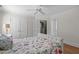 Comfortable bedroom with hardwood floors, closet space, and natural light from windows at 2704 Fairview Rd, Raleigh, NC 27608