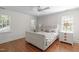 Bright bedroom with hardwood floors, a ceiling fan, and natural light from large windows at 2704 Fairview Rd, Raleigh, NC 27608