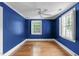 Inviting bedroom with hardwood floors, ample natural light, and ceiling fan at 2704 Fairview Rd, Raleigh, NC 27608