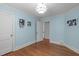 Cozy bedroom featuring blue walls, hardwood floors, and decorative crown molding at 2704 Fairview Rd, Raleigh, NC 27608