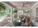 Charming covered porch featuring brick flooring, comfortable seating, and lush landscaping at 2704 Fairview Rd, Raleigh, NC 27608