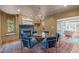 Elegant dining room with a fireplace, large windows, and comfortable seating at 2704 Fairview Rd, Raleigh, NC 27608